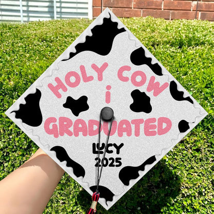 An amusing personalized gift for graduates, this 'Holy Cow' cap topper graduation accessory adds a playful touch.